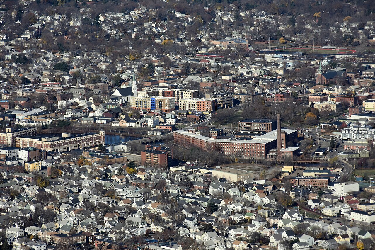 Historical aerial photograph of central Waltham, showing the Charles River, Moody Street bridge and buildings on both banks.